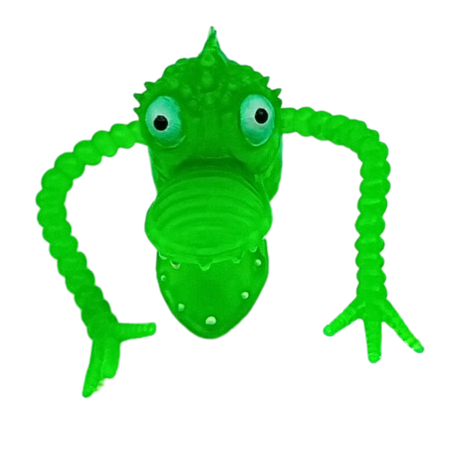 A green plastic finger puppet in the shape of a monster with wild eyes and pointy teeth